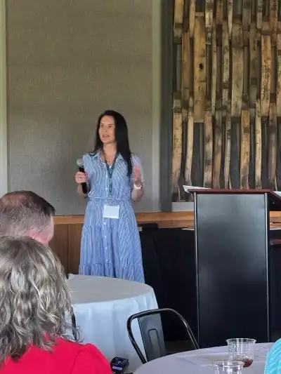 image of a woman speaking to a group of people